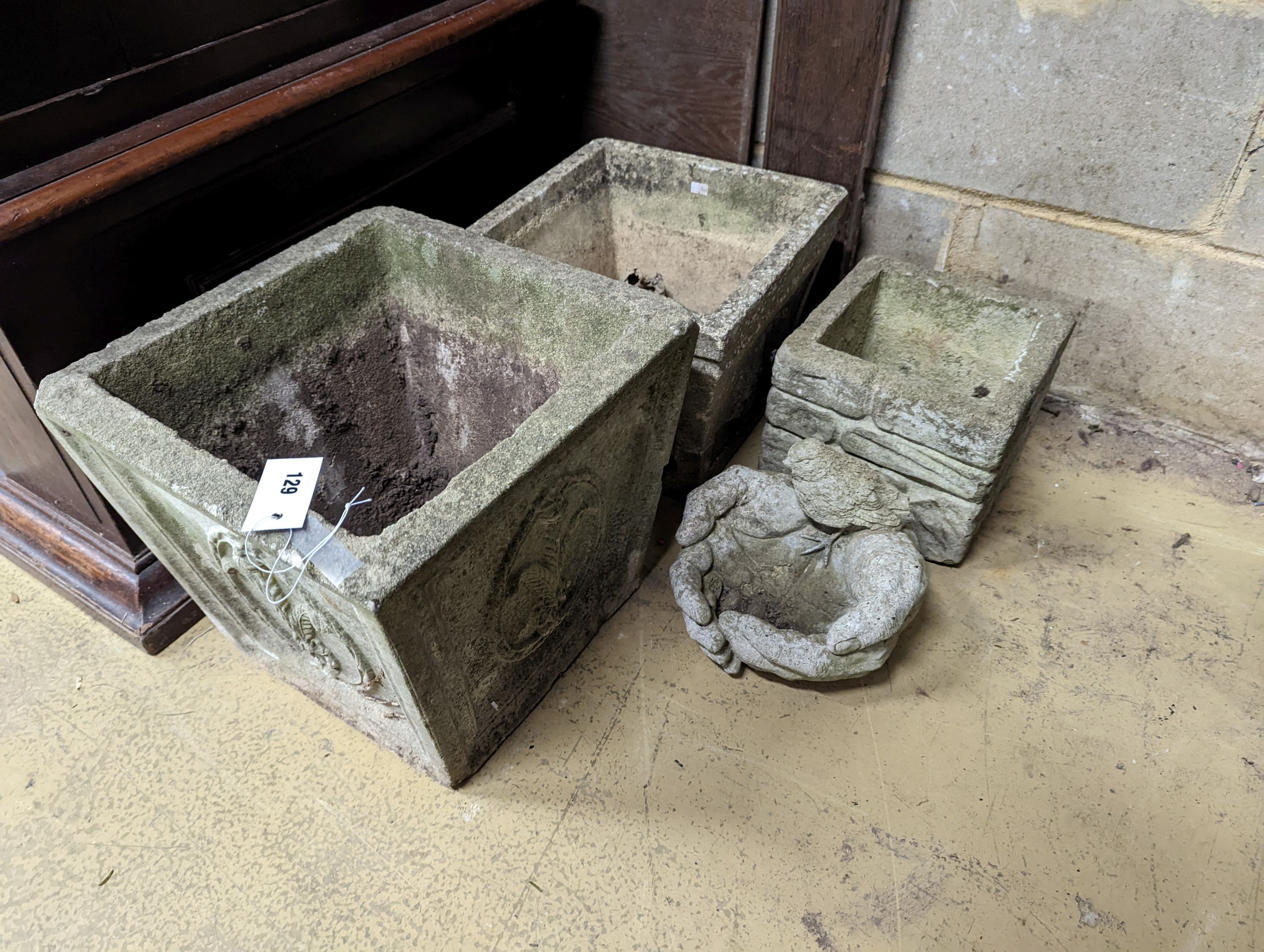 Three square reconstituted stone garden planters together with a bird bath, largest height 32cm